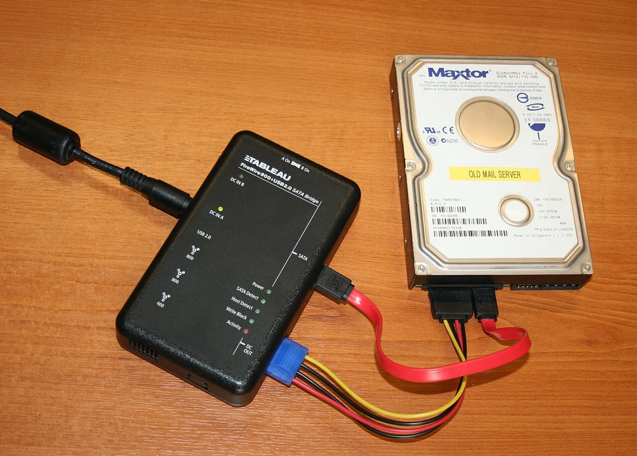 A portable Tableau write-blocker attached to a hard drive.