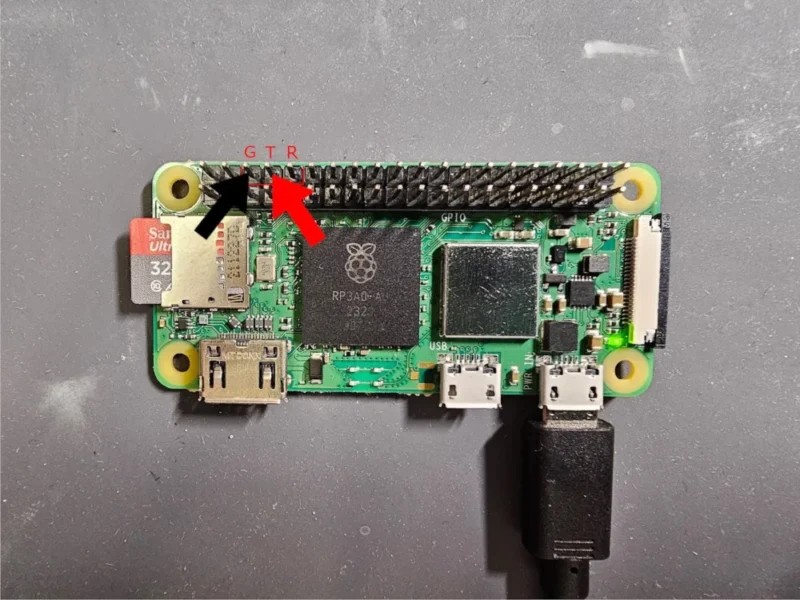 raspberry pi with red arrow pointing to tx and black arrow point to ground connections